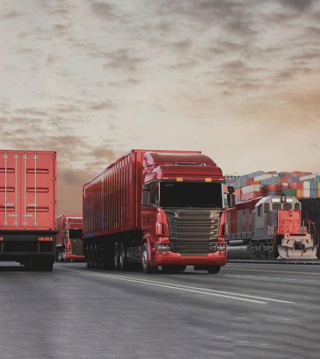 Trucks and cargo ship at a port - Goods in Transit Insurance