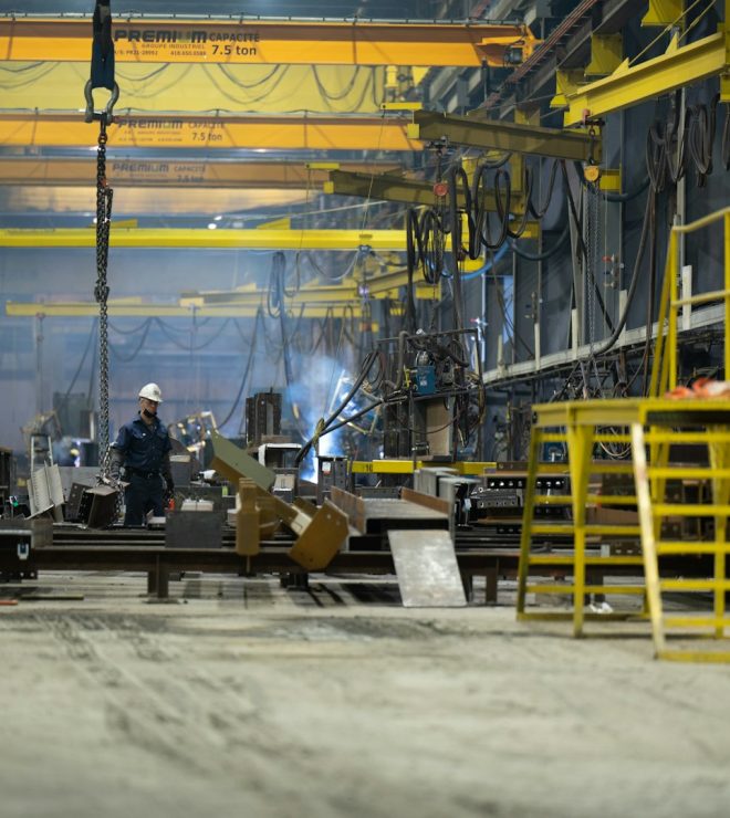 Man standing in front of factory machinery - Machinery